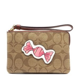 Coach corner zip wristlet in signature canvas with motif